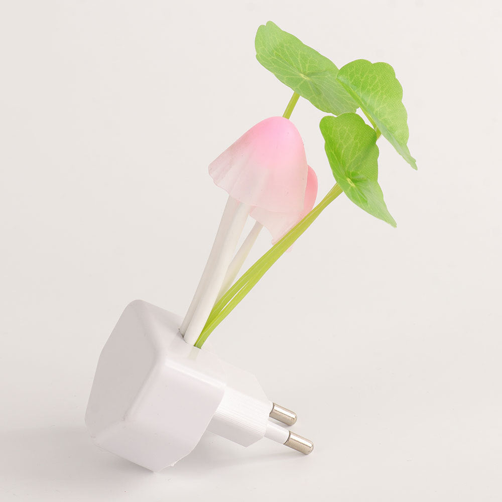 White wall plug with a pink flower and green leaves on a light gray background